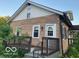 Home's front entrance featuring a stone facade and a small porch area at 4943 S State Ave, Indianapolis, IN 46227