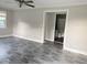 Bright living room boasts new gray flooring and neutral paint palette at 4943 S State Ave, Indianapolis, IN 46227