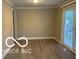 Bright living room with updated floors and a sliding glass door providing access to the backyard at 4943 S State Ave, Indianapolis, IN 46227