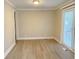 Neutral living room with new floors and a sliding glass door at 4943 S State Ave, Indianapolis, IN 46227