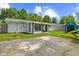 The backyard highlights a generous patio space, an expansive yard, and a versatile storage shed at 5115 Bertha St, Indianapolis, IN 46241