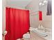 Bathroom with a shower behind a red curtain, toilet, and vanity at 5115 Bertha St, Indianapolis, IN 46241