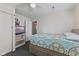 Bedroom with a ceiling fan, television, closet, and doorway to another room at 5115 Bertha St, Indianapolis, IN 46241