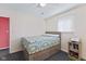 Bedroom with bed, side table, and window at 5115 Bertha St, Indianapolis, IN 46241