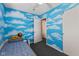 Whimsical bedroom featuring cloud mural, twin bed, and walk-in closet at 5115 Bertha St, Indianapolis, IN 46241