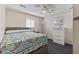 Comfortable bedroom with a ceiling fan, window and dresser at 5115 Bertha St, Indianapolis, IN 46241