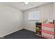 Cozy bedroom with neutral walls, a bright window, and functional furnishings at 5115 Bertha St, Indianapolis, IN 46241
