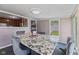 An inviting dining area featuring a table with marble top, comfortable seating, and abundant natural light at 5115 Bertha St, Indianapolis, IN 46241