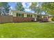 A well-maintained home featuring brick accents, a covered front porch, and a green lawn at 5115 Bertha St, Indianapolis, IN 46241