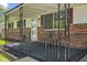 Cozy covered front porch with decorative railing, seating, and views of the surrounding yard at 5115 Bertha St, Indianapolis, IN 46241