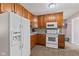Kitchen featuring wooden cabinets, gray counters, tiled backsplash, and appliances at 5115 Bertha St, Indianapolis, IN 46241