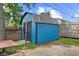 The property features a well-maintained blue storage shed with a durable roof and double doors at 5115 Bertha St, Indianapolis, IN 46241
