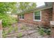 Exterior view of the backyard deck with weeds growing through the planks at 530 Westmore Dr, Indianapolis, IN 46214