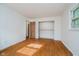 Bright bedroom with wood floors, white brick accent wall and closet with sliding doors at 530 Westmore Dr, Indianapolis, IN 46214