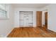 Bedroom with hardwood floors, closet with shelving and door leading to another room at 530 Westmore Dr, Indianapolis, IN 46214