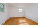 Neutral bedroom with hardwood floors and white painted brick accent wall at 530 Westmore Dr, Indianapolis, IN 46214