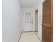 Hallway leading to an exterior door and a closet, featuring light-colored walls and trim at 530 Westmore Dr, Indianapolis, IN 46214