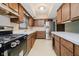 Traditional kitchen offering ample cabinet space, stainless steel fridge, and laminate countertops at 530 Westmore Dr, Indianapolis, IN 46214