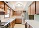 Well-lit kitchen with wood cabinets, stainless steel appliances, and white countertops at 530 Westmore Dr, Indianapolis, IN 46214