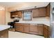 Kitchen with dated brown cabinets, older appliances, and laminate countertops needs upgrading at 530 Westmore Dr, Indianapolis, IN 46214