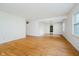 Living room with hardwood floors and white walls, open to the entryway and adjacent rooms at 530 Westmore Dr, Indianapolis, IN 46214