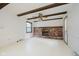 Bright living room with a classic brick fireplace, wooden beams, and ample space at 530 Westmore Dr, Indianapolis, IN 46214