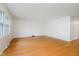 Bright living room featuring hardwood floors and white walls, with large windows providing ample light at 530 Westmore Dr, Indianapolis, IN 46214