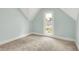 Bright bedroom featuring carpeted floors and a window with a view of the neighborhood at 538 N East St, Greenfield, IN 46140