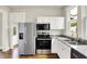 Updated kitchen with stainless appliances, granite counters, and ample cabinet space at 538 N East St, Greenfield, IN 46140