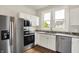 Modern kitchen with stainless steel appliances, granite countertops, and white cabinetry at 538 N East St, Greenfield, IN 46140