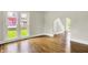 Bright living room featuring wood floors, large windows, and arched doorways at 538 N East St, Greenfield, IN 46140