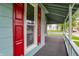 Covered porch with crisp white railing and red shutters, offering a relaxing outdoor space at 538 N East St, Greenfield, IN 46140