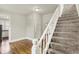 Staircase leading to upper level with freshly painted walls and plush gray carpet at 538 N East St, Greenfield, IN 46140