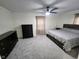 Spacious carpeted bedroom with ceiling fan, two dressers, and lots of natural light at 5433 Brendonridge Rd, Indianapolis, IN 46226