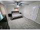 Spacious carpeted bedroom with ceiling fan, dresser, and two closets at 5433 Brendonridge Rd, Indianapolis, IN 46226
