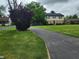 Charming two-story home with a well-manicured lawn and long driveway at 5433 Brendonridge Rd, Indianapolis, IN 46226