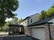 Exterior view of the back of the house with screened in patio and attached garage at 5433 Brendonridge Rd, Indianapolis, IN 46226