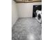 Functional laundry room offers neutral paint, modern gray vinyl flooring, and convenient washer and dryer hookups at 5433 Brendonridge Rd, Indianapolis, IN 46226
