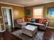 Inviting living room with plush sectional sofa, ottoman, and colorful decor at 5433 Brendonridge Rd, Indianapolis, IN 46226