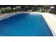Inviting in-ground pool surrounded by concrete patio for ultimate relaxation and backyard enjoyment at 5433 Brendonridge Rd, Indianapolis, IN 46226