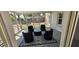 The sunroom features stylish seating around a glass table on a decorative rug, bathed in natural light at 5433 Brendonridge Rd, Indianapolis, IN 46226