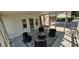 A sunroom displays a circular seating arrangement on a decorative rug, with ample natural light at 5433 Brendonridge Rd, Indianapolis, IN 46226
