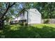 Green backyard featuring the home's exterior and a fenced perimeter, showcasing its tranquil outdoor space at 5522 Closser Ct, Indianapolis, IN 46221