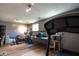 Finished basement featuring gym equipment, laminate flooring, and a cozy cat tree, creating a versatile workout space at 5522 Closser Ct, Indianapolis, IN 46221