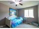 Cozy bedroom with light gray walls, white trim, ceiling fan, and picture window at 5522 Closser Ct, Indianapolis, IN 46221