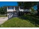Charming split-level home featuring a brick facade, siding, and well-maintained lawn at 5522 Closser Ct, Indianapolis, IN 46221