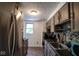 Efficient kitchen features stainless steel refrigerator and granite countertops with tile backsplash at 5522 Closser Ct, Indianapolis, IN 46221
