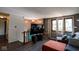 Living room with hardwood floors, large TV, and large windows offering plenty of natural light at 5522 Closser Ct, Indianapolis, IN 46221