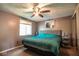 Cozy bedroom featuring a comfortable bed, a ceiling fan, and natural light from the window at 5522 Closser Ct, Indianapolis, IN 46221