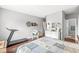 This bedroom has hardwood floors, a chair, and a view into the bathroom and hallway at 5619 Payne Blvd, Plainfield, IN 46168